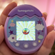 A photo of the Tamagotchi Pix with a pixelated Ramen on the screen